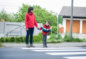 Woman and child looking before crossing the road
